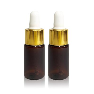 China Wholesale 10ml PET Hair Oil Cosmetic Empty Amber Serum Bottle Custom Plastic Essential Oil Dropper Bottle With Gold Lid for sale