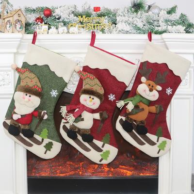 China Nonwoven + Custom Hanging Plush Christmas Socks Decoration Santa Claus /Snowman/Elk Pattern Christmas Bumping For Festival Gift for sale