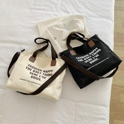 China Fashion Fashion Canvas Letter Wholesale Messenger Bag Portable Tote Bag High Capacity Tote Handbag For Wome for sale