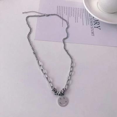 China Environmentally friendly titanium steel smiling face pendant necklace hip-hop style personality clavicle chain stitching female light luxury new for sale