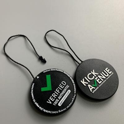 China StockX Viable Custom Plastic Seal Hang Tags 3D Embossed Authentic Verified Green Round Shoes Apparel Garment Tag for sale