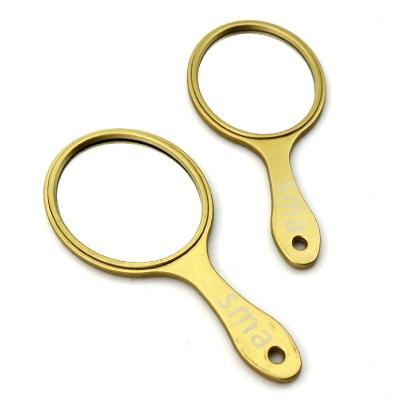 China Small One Side Oval Shape Princess Hand Makeup Magnifying Plastic Gold Cosmetic Mirror for sale