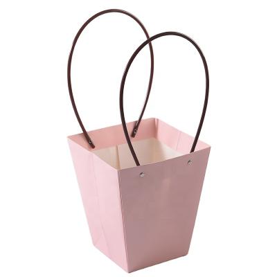 China Luxury Recycled Material Supplier Super Pink Kraft Paper Bags With PVC Handle Logo Waterproof Flower Paper Bag Custom Made for sale