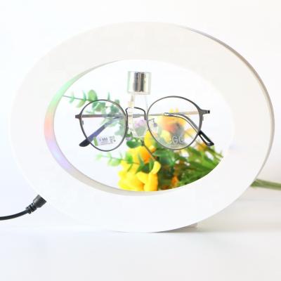 China Morden Wholesale Prices Led Magnetic Levitation Rotating Acrylic Glasses For Display Oval Shape 100-240VAC Black White Color for sale