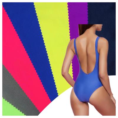 China Stretch Wholesale 200gsm 4 Way Stretch Warp Knitted Polyester 88 12 Lycra Swimwear Fabric Spandex Shorts for sale