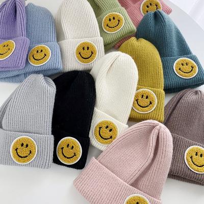 China Fashion COMMON Women's Smile Face Patch Hat Winter Student Couple Woolen Knitted Beanie Thermal Hat for sale