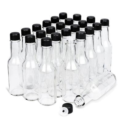 China 5oz 150ml Empty Clear Food Hot Sauce Glass Bottles With Spout Inserts And Black Screw Caps With Food Grade Liner for sale