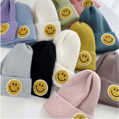 China COMMON hot sale 2021 autumn winter accessories smile face hat ear protector wool knitted multicolor warm hat for sale