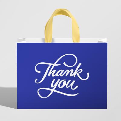 China Recycled Materials Brand Logo Design Promotion Luxury Clothing Paper Bag Custom Printed Gift Bag With Ribbon Navy Blue Gift Bags for sale