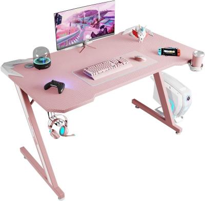 China (Size) Brunei Adjustable Popular Pink Gaming Computer Desk PC Gaming Desk Z Shaped Gamer Workstation With Carbon Fiber Surface Cup Holder for sale