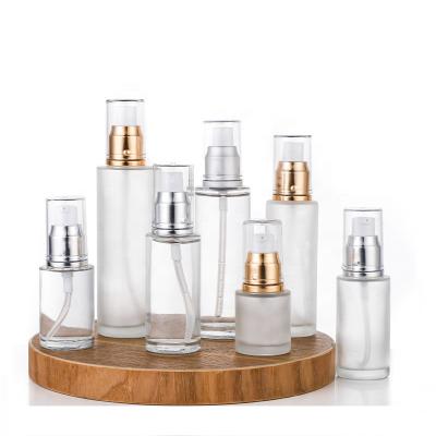 China Personal care frosted clear glass cosmetics containers 20ml 30ml 40ml 50ml 60ml 80ml100ml and lotion packaging glass bottles with pump for sale