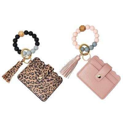 China Easy To Match Clothes Fashion Tassel Food Grade Silicone Beaded Metal Key Chain Card Key Bracelet Bangle PU Coin Purse Ring Wallet For Women for sale