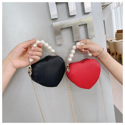 China Lovely Portable Wholesale Pearl Handle Bags For Kids Mini Shoulder Bag Girls Cute Purses Heart Shaped Handbags for sale