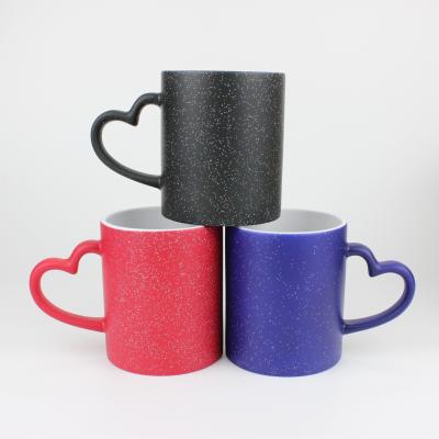 China Eco-Friendly Custom Classic Ceramic Coffee Mugs With Logo Hot Water Changing Color Mugs Movie Item Mug Glitter Heart Handle Magic Gift for sale