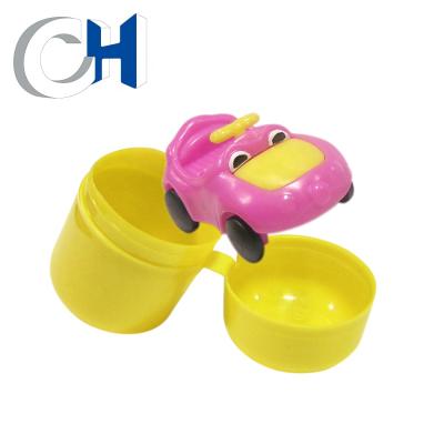 China Training Kids Ability Promotional Creative 40mm Pink And Yellow PP Cartoon Car Capsule Action Toy for sale