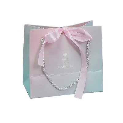 China Wholesale Recyclable Luxury Cardboard Wedding Gift Paper Bag With Handle Bow Delicate Gift Paper Bag for sale