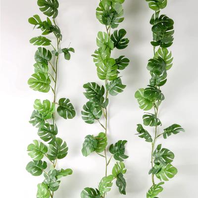 China Minimalist Artificial Monstera Plants Faux Leaf Tropical Greenery Hanging Vines For Hawaiian Beach Party for sale