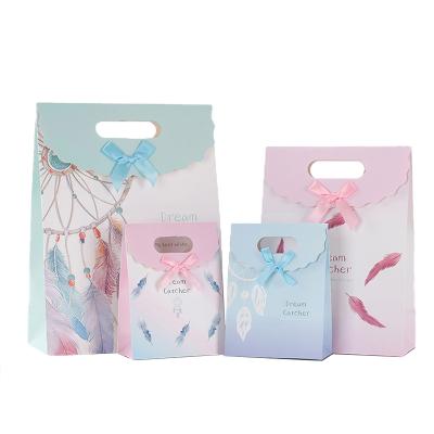 China Beautiful New Design Disposable Design Handle Printing Paper Bags For Girl Clothing Birthday Gift Packaging for sale