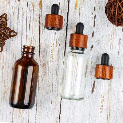 China Personal Care Clear 30ml Essential Oil Bottles With Glass Scale And Dropper, Rubber Head And Wooden Cap for sale