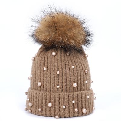 China Wholesale JOINT Thermal Knitted Giant Raccoon Fur Ball Hats For Both Men And Women for sale