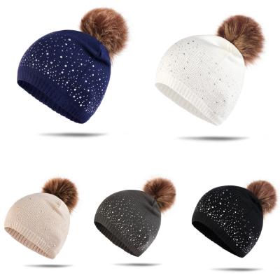 China Fashion Faux Stone Winter Beanie Hat With Glitter And Big Faux Fur Pompom Ladies Winter Hat for sale