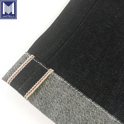 China Stocklot wholesale price 100% raw cotton Japanese style selvedge denim fabric Shrink-resistant for iron heart motorcycle knight jeans for sale