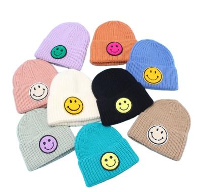 China COMMON Good Quality New Winter Fashionable Children's Warm Knitted Hat Candy Colors Cute Smiley Face Wool Hat Beanie Knitted Hats For Kids for sale