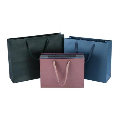 China Recyclable Custom Large Clothing Store Tote Bag Gift Packaging Bag Ribbon Custom Paper Shopping Bag for sale