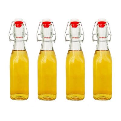 China Freshness Retention Set Of 4 8.5oz Swing Top Beer Milk Glass Water Juice Bottle With Flip Top Stoppers 250ml for sale