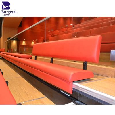 China Multifunctional Hall Wall Attached Retractable Auditorium Seating With Customized Red Fabric Covered Bench Seating for sale