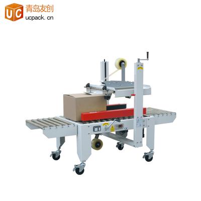 China Semi Automatic Carton Box Food Adhesive Tape Sealer Folding Sealing Packing Machine for sale