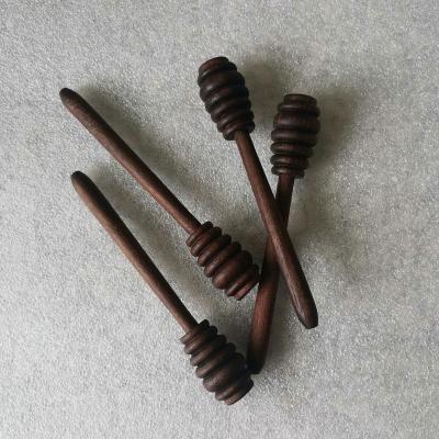 China Long Handle Eco-Friendly Sustainable Wooden Honey Spoon Reusable Black Walnut Honey Stick Home Dessert Tools for sale