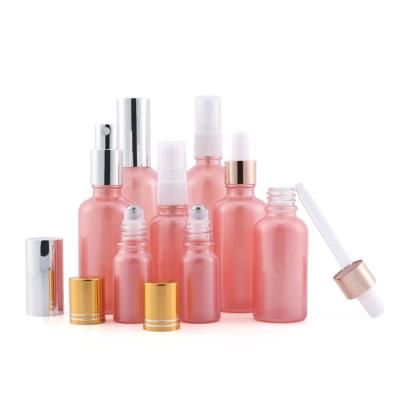 China Hot Sale 15ml 30ml Pearl Pink Custom Bottle Manufacturers Personal Care Massage Oil Glass Spray Bottle With Aluminum Dropper for sale