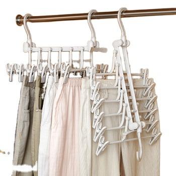 China Magic Double Hook Space Saving PP Wardrobe Pants Hangers Wholesale Viable Foldable Plastic Tiered Trouser Hanger for sale