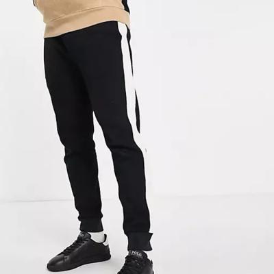 China Anti-Wrinkle OEM Logo Custom Mens Mud Fit Joggers Pants Black Stripe for sale