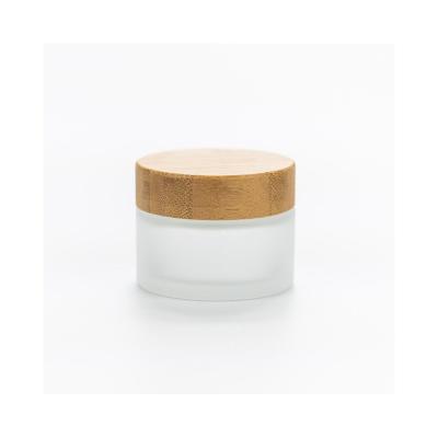 China Cosmetic empty clear frosted cream wooden & bamboo jars wholesale cosmetic glass jar with bamboo lid for sale