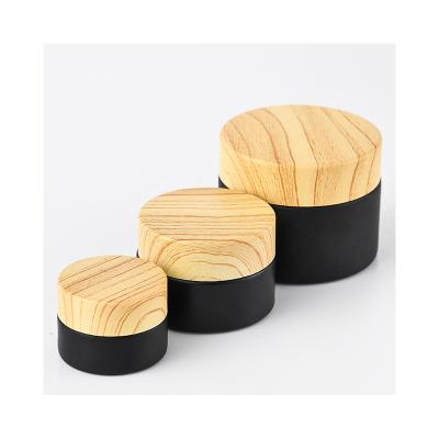 China Cosmetic Cosmetics packing Frosted matt glass jar with bamboo lid black bamboo jar bamboo lid glass jars for sale