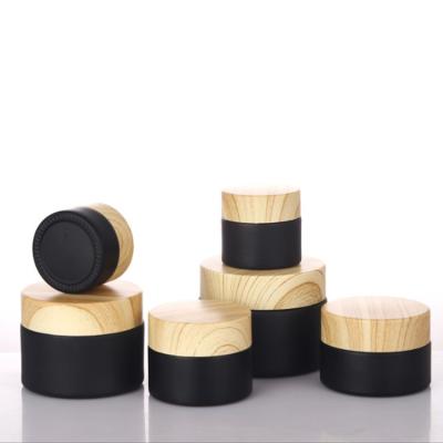 China Cosmetic Wholesale cream container frost Round bamboo jars matte black jar with bamboo lid glass jars for sale