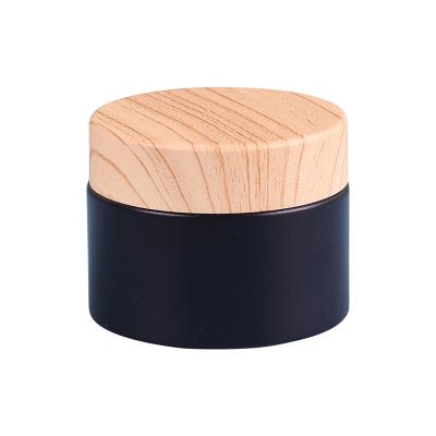 China Cosmetic Empty Round packaging wooden & bamboo jars black cosmetic jar bamboo lid dark cosmetics jar for sale