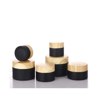 China Cosmetic Frosted glass Empty Cosmetic packaging bamboo cream jar black jar with bamboo lid for sale