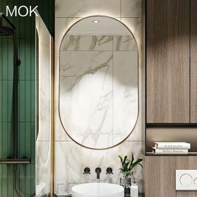 China Modern Luxury Hotel Bathroom Gold Metal Frame Pill Wall Mirror for sale