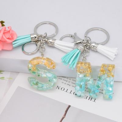 China New Eco-friendly Tassel Keychain 26 English Alphabet White Resin With Gold Foil Women Key Chain Handbag Charms Accessories Christmas Gift for sale