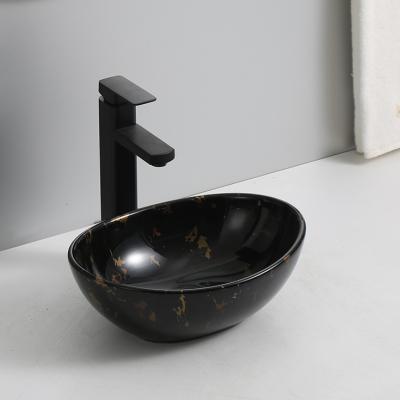 China Modern Decorative Oval Black Marble Basin Countertop Bathroom Ceramic Sink Marble Bathroom Sink for sale