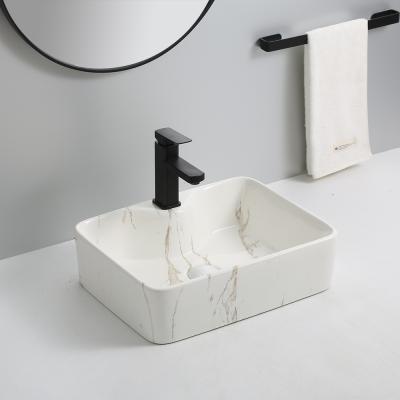 China Modern Unique Design Ceramic Sinks Bowl Marble Above Counter Basin Ceramic Sanitary Ware Bathroom Marble Sinks for sale