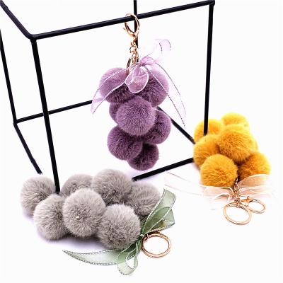 China Fashion Creative Grape Fruit Cute Bowknot Lace Plush Ball Pendant Hairy Bag Accessories Chain Key Bag Key Chain for sale