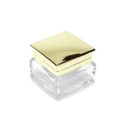 China Luxury Personal Care Skin Care Body Cream Container Packaging Square 50ml Glass Cosmetic Jar With Gold Lid for sale