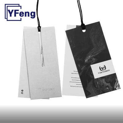 China Viable High Quality Customized LOGO Deboss Printing Apparel Garment Gift Certificate Kraft Paper Craft Cardboard Swing Hang Tag With String for sale