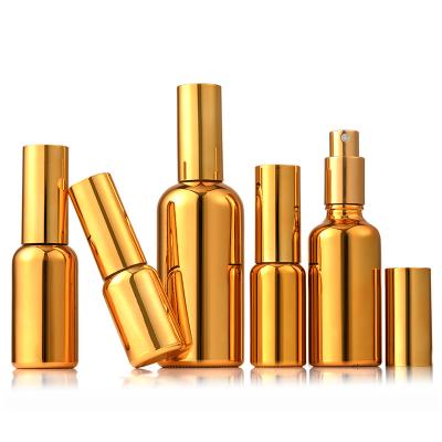 China Eco-friendly Recyclable Luxury 10ml15ml30ml50ml100ml Round Shape Essential Oil Bottle Perfume Spray Gold Plated Glass Bottle for sale