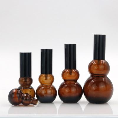 China 10ml 20ml 30ml 50ml 100ml Amber Double Gourd Shape Glass Essential Oil Cosmetic Bottle With Dropper for sale