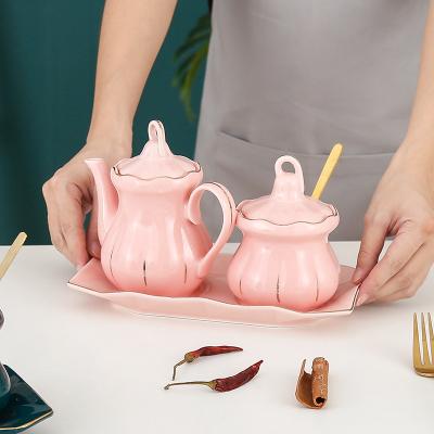 China Viable Durable Rim Kitchen Gold Shape Pumpkin Spice Oil Dispenser Set Oil Ceramic Vinegar Bottle With Tray And Spoon for sale